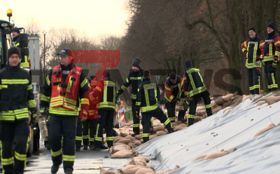 Reißende Stromschnellen - verbarrikadierte Kellerfenster - wasserführende Schläuche aus Kellerfenstern - weiterer Damm droht zu brechen - Einsatzkräfte verstärken ihn mit Sandsäcken - Radlader transportiert palettenweise Sandsäcke: Im O-Ton Anwohner , sie berichten von den Erlebnissen mit dem Hochwasser